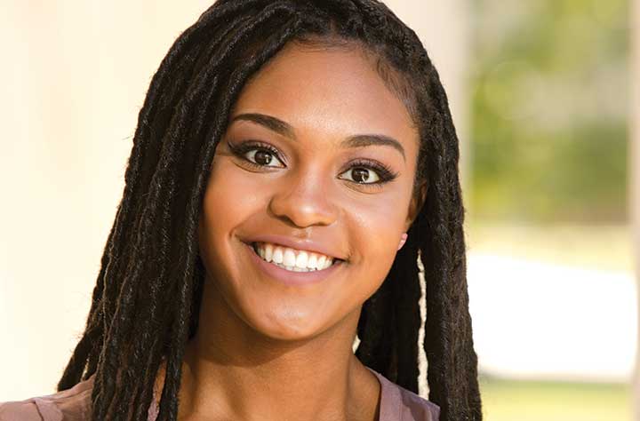 ZAHNA BIGHAM smiles for the camera outside.