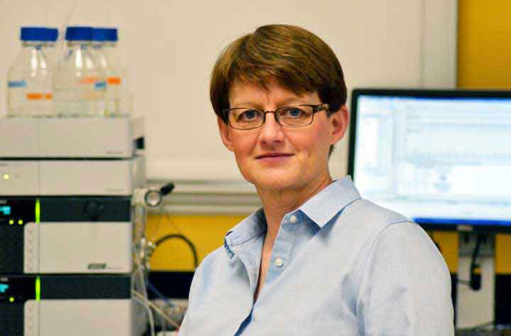 Faculty member Glenda Ferguson sits in her lab