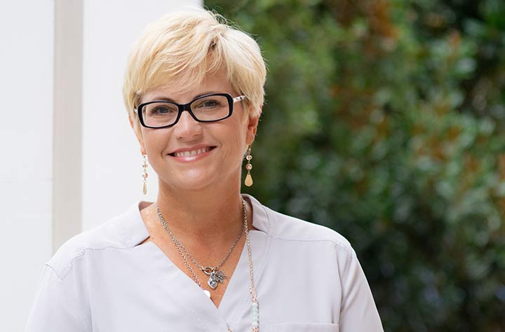 Jill Amos poses in her office