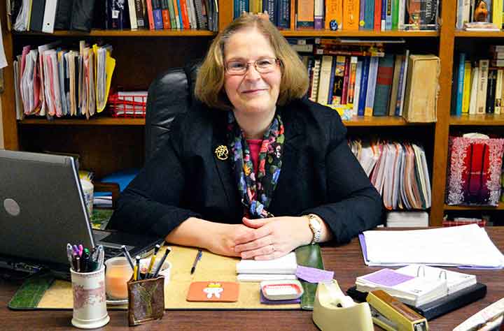 Regina B. Oost sitting at her desk in her office