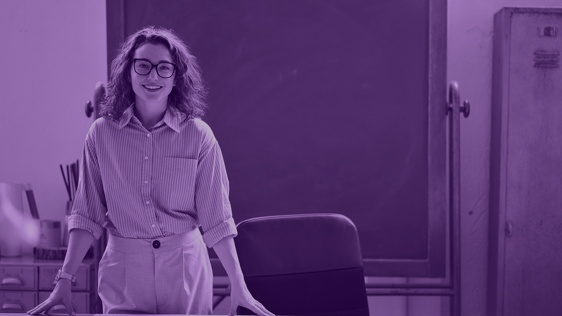 Photo of a female teacher in the front of a classroom