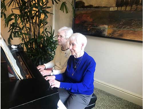 Alumnae at piano