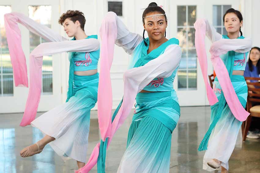 Three students dress and dance during AXIS dinner.