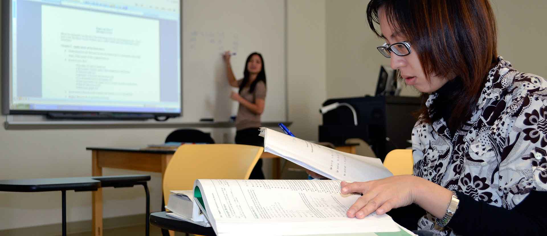 Student in Math class working on formulas.