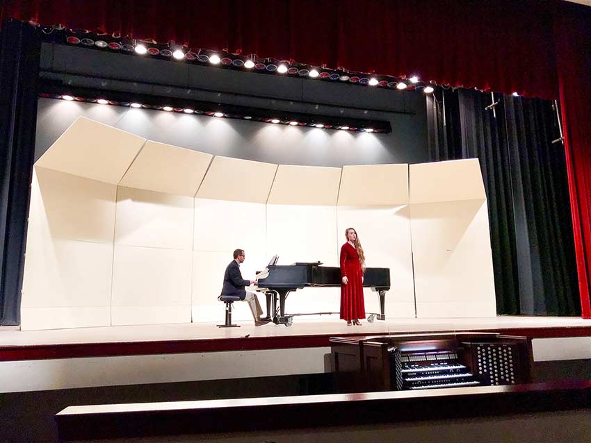 Student singing on stage.