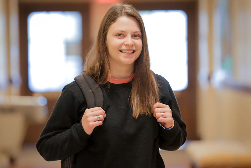 Student walking to class with her backpack